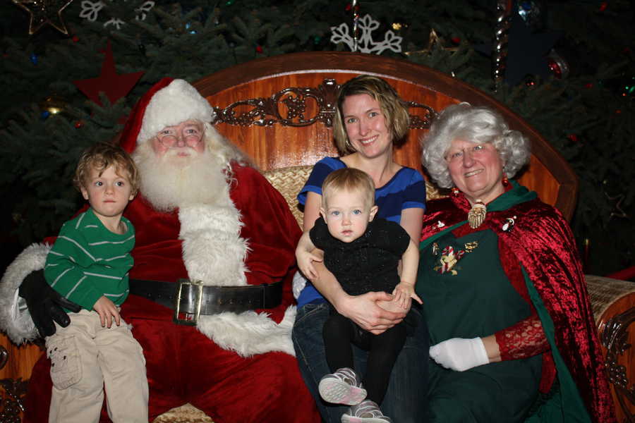 Kim and her two kids pose with Santa and Mrs. Claus at The Durham Museum