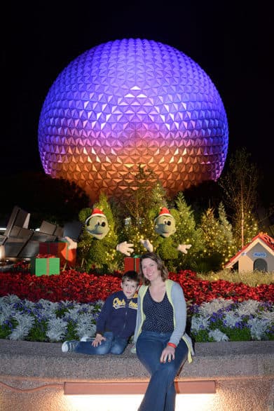 Photo in front of iconic Spaceship Earth at Epcot at Christmas time