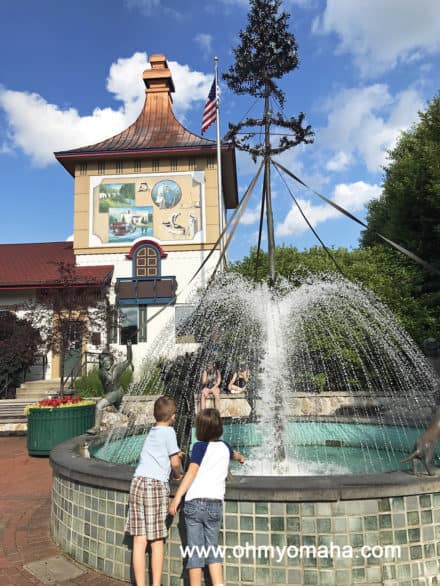 Two kids stand in front of a fountain in Frankenmoth, Michigan