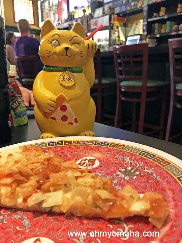 Slice of crab rangoon pizza and a tiki drink at Fong's Pizza in Des Moines