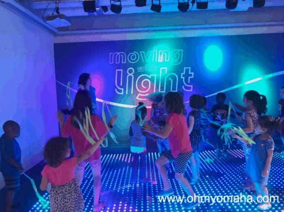 Dancing in the Moving With Light exhibit at Omaha Children's Museum