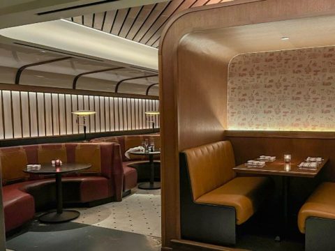 Booths in the dim dining room of Committee Chophouse