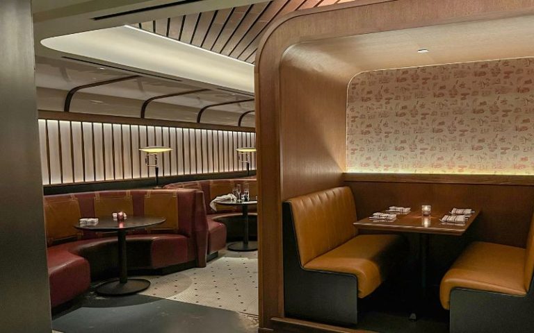 Booths in the dim dining room of Committee Chophouse