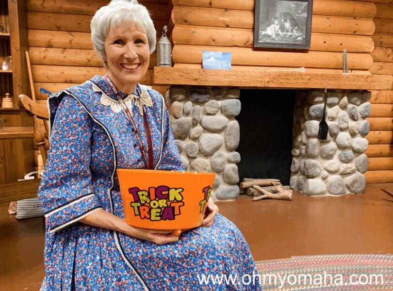 A volunteer handing out candy at The Durham Museum's Great HALL-oween Haunt.