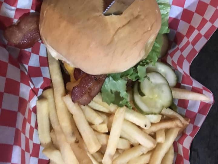 Loaded cheeseburger and fries basket at Dinker's