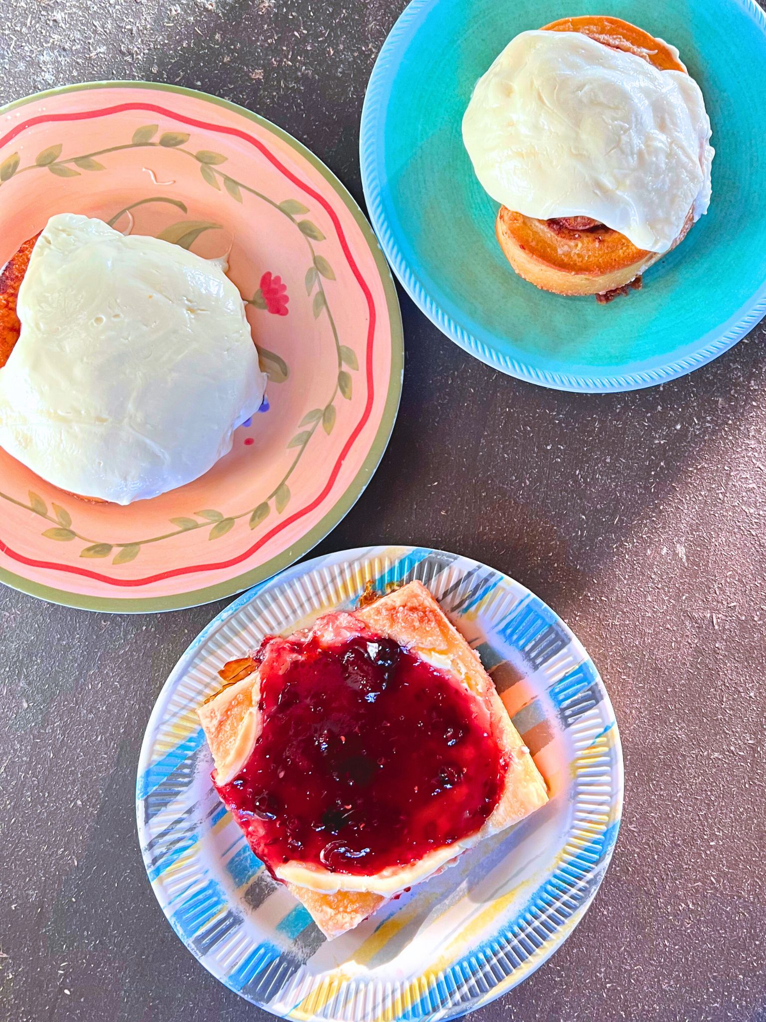 Overhead photo of three desserts sitting on colorful plates