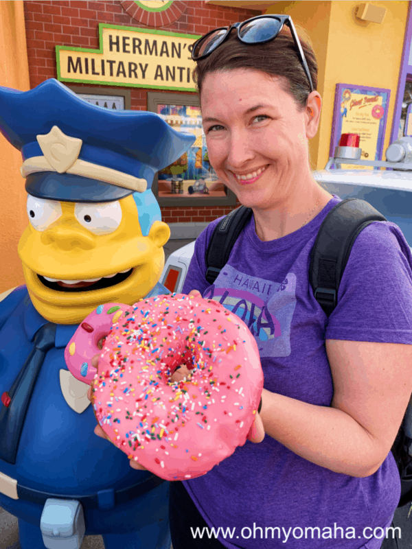 Kim and a giant pink frosted donut at Universal Studios Hollywood