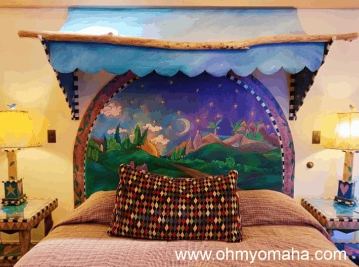 Bed in the travel-themed junior suite at Hotel Pattee
