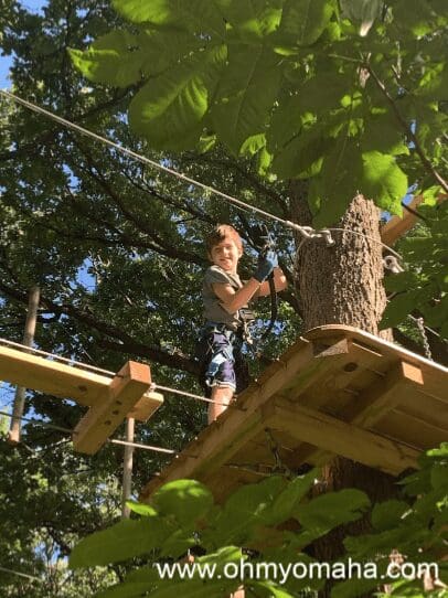 Smiling boy on ropes course in Nebraska