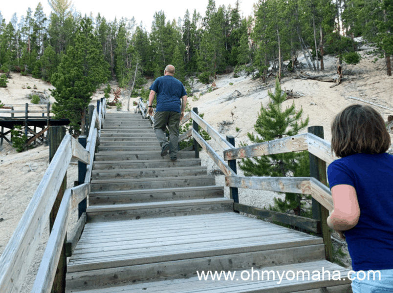 Dad and daughter walking up stairs at Mud Volcano trail in Yellowstone National Park.