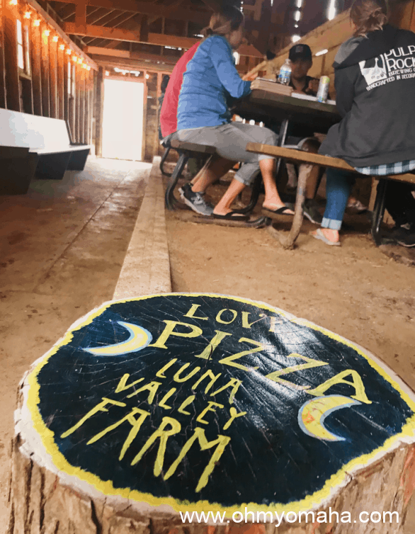 Guests eating pizza inside a barn at Luna Valley Farm in Decorah, Iowa.