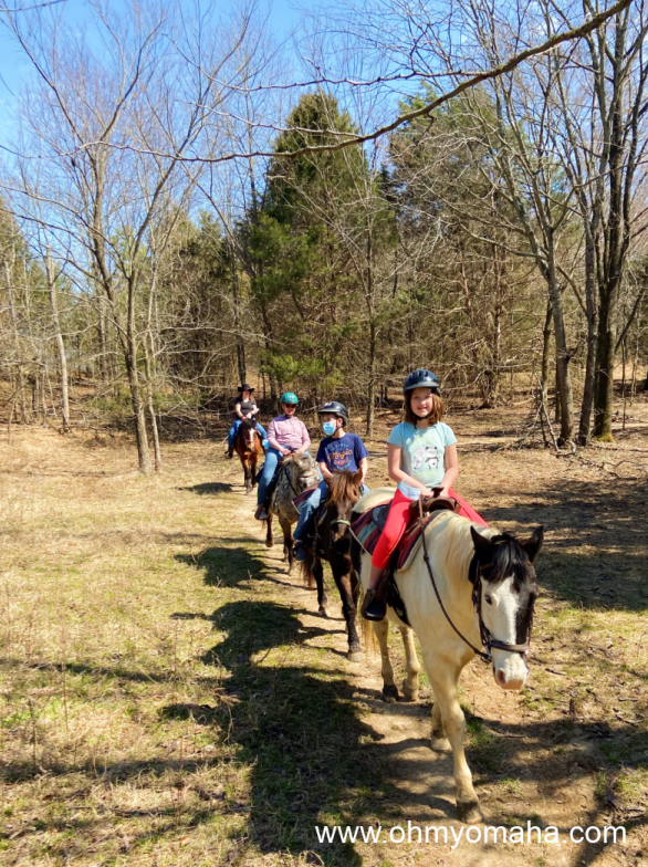 Riders wearing helmets on a trail ride at Shelby Farms Park in Memphis, Tenn.