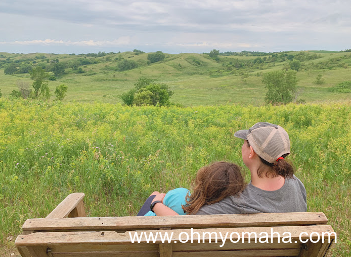 Mom and daughter on a bench overlooking the Broken Kettle Grasslands, a prairie in the Loess Hills