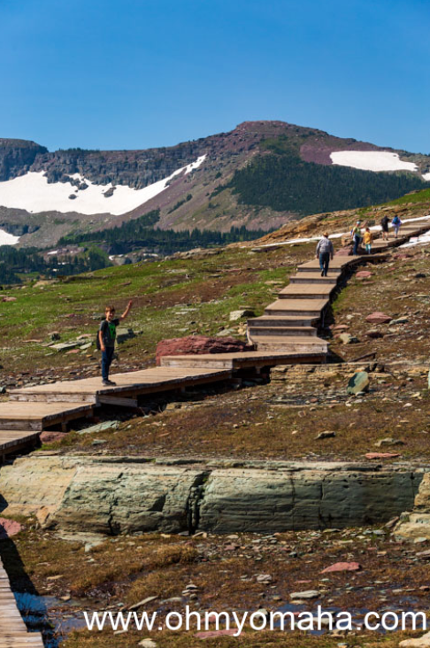 Boy on the stairs at Hidden Lake Overlook Trail at Logan Pass