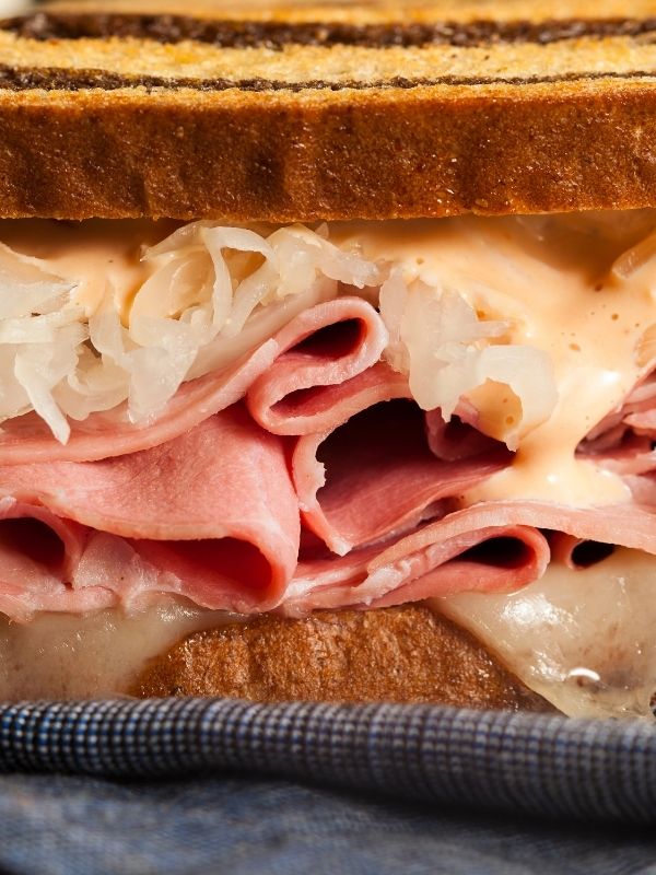 A close-up photo of a Reuben sandwich