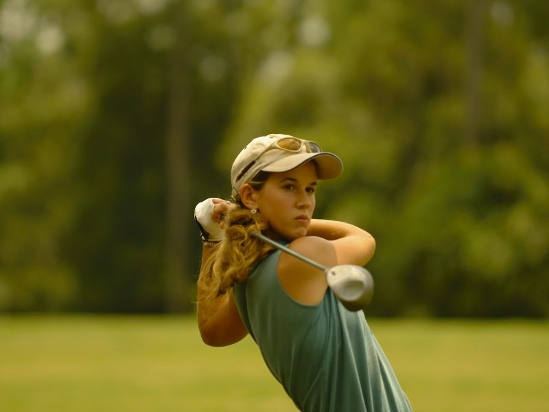Young woman golfing