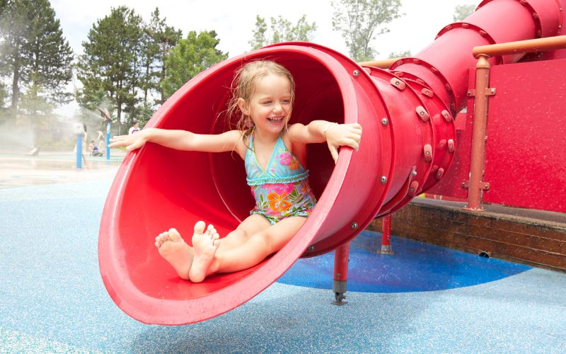 Girl on red water slide
