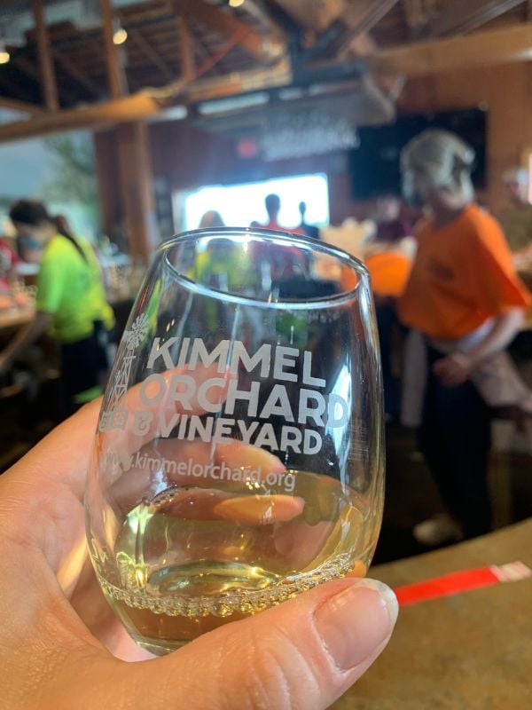 An up-close photo of a stemless wine class that reads Kimmel Orchard & Vineyards on it