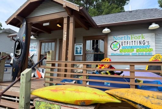 The exterior of North Fork Outfitting with kayaks on display