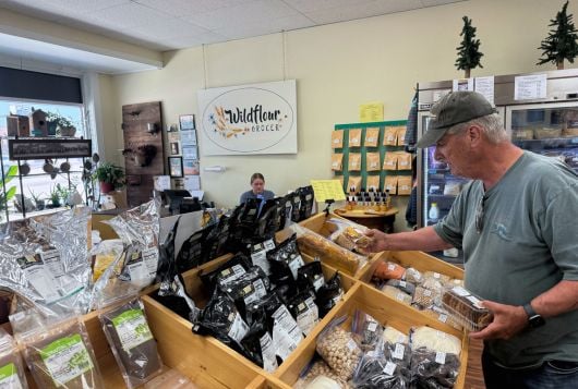 A man browses items inside Wildflour Grocer in O'Neill