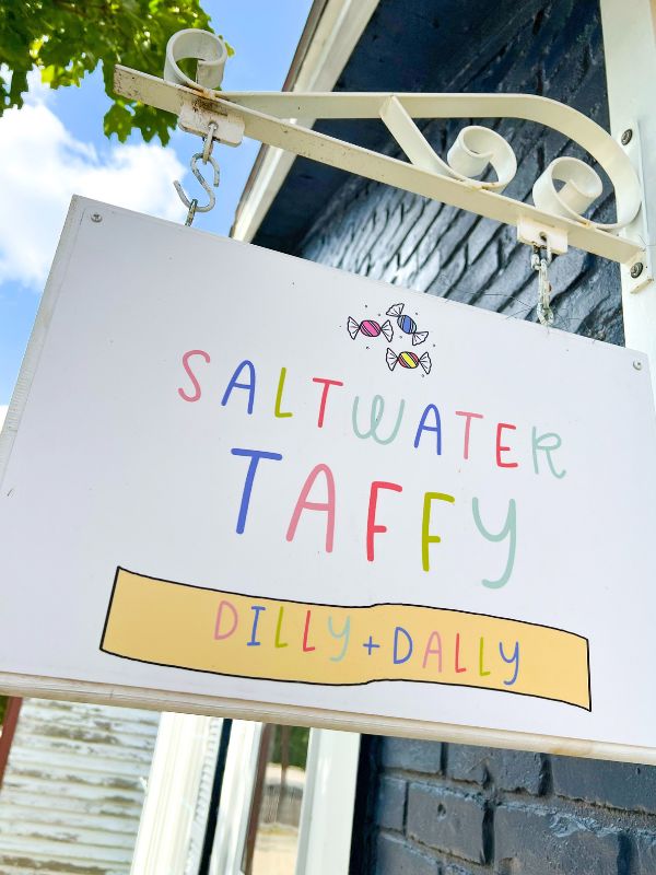 A sign for a saltwater taffy shop on Main Street in Brownville