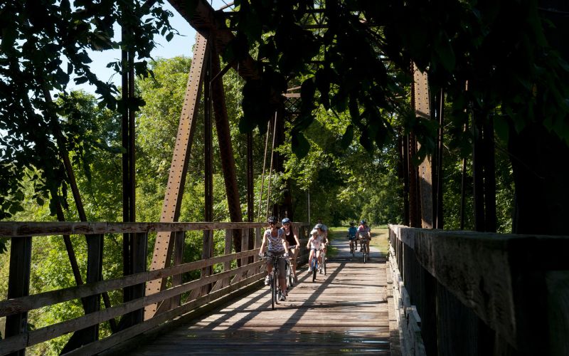 Biking on the Root River bike trail in Lanesboro over an old railroad bridge