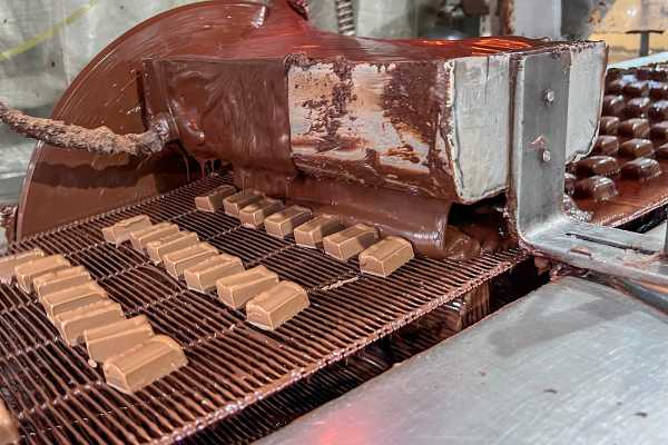 Chocolate meltaways get coated with more chocolate in a fully-automated process