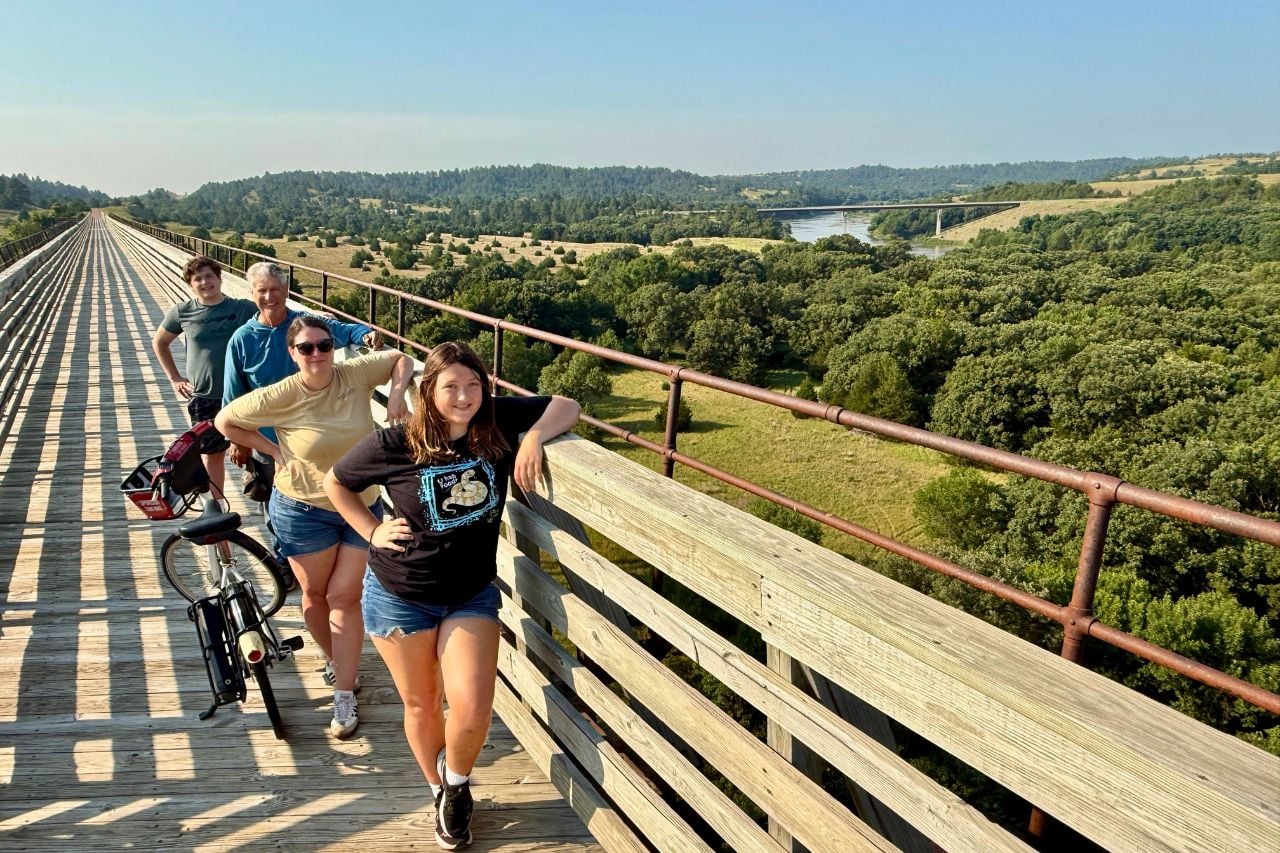 Kim and her family stand on a bridge on the Cowboy Trace Trail