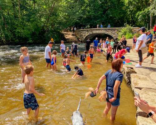 Families play in the water at Minnehaha Park