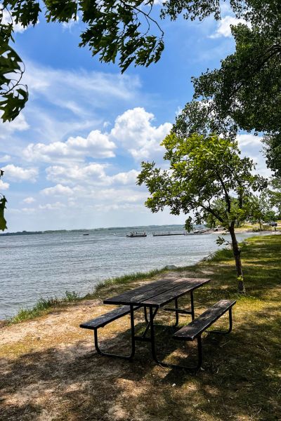 A picnic table in the foreground with the Calamus Reservoir in the background