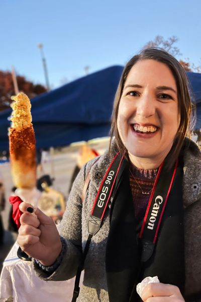 Megan from Olio in Iowa eats elote during Day of the Dead festivities