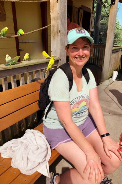 Kim sitting among the birds at Omaha's zoo