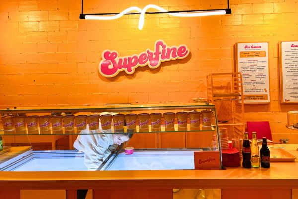 A girl scoops ice cream at Superfine Sweet Shoppe in Bentonville