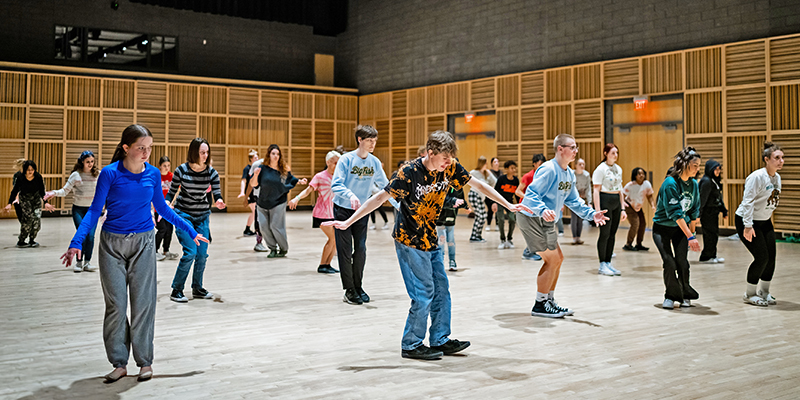 Student dancers learn dance moves from Ballet Hispánico 