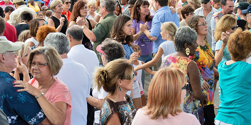A crowd of people dance during a Ballet Hispánico Social Dance Workshop