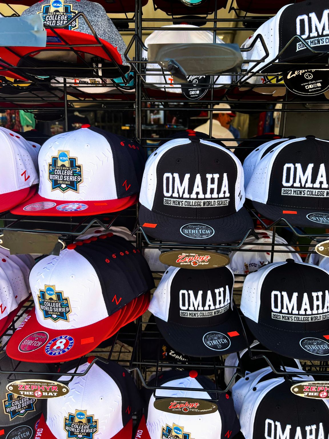 A display of hats from the College World Series