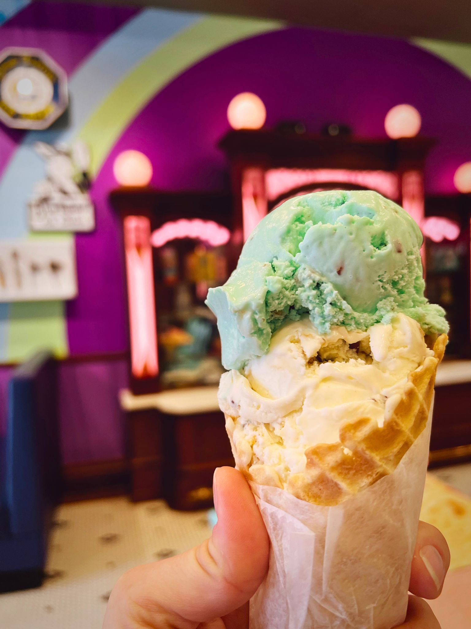 A waffle cone held up inside the Wells Visitor Center & Ice Cream Parlor in Le Mars