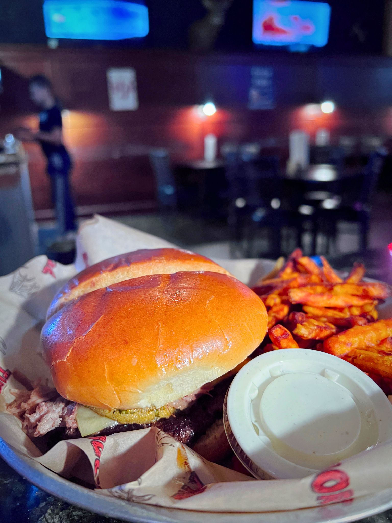 A basket with a burger and sweet potato fries at Buck Snort in Glenwood