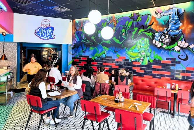 The interior of JoJo's Diner in Benson, with a large mural on the back wall and red leather seats