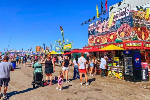 A line of people wait at a food vendor at the Nebraska State Fair