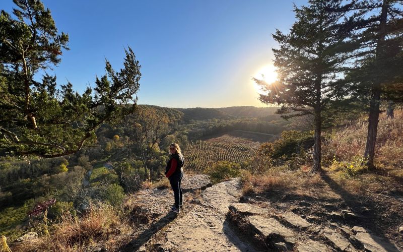 Kim standing at an overlook at Yellow River State Park in Iowa