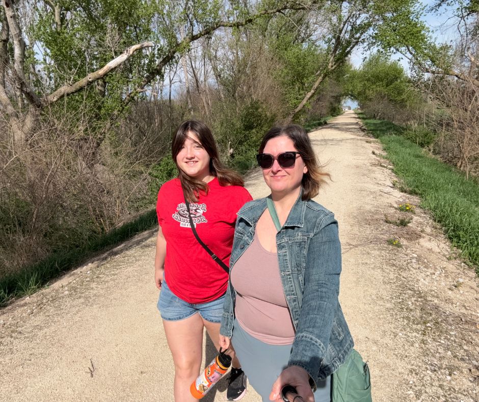 Kim and her daughter walk on the Three Rivers Trail at Rolfe, Iowa