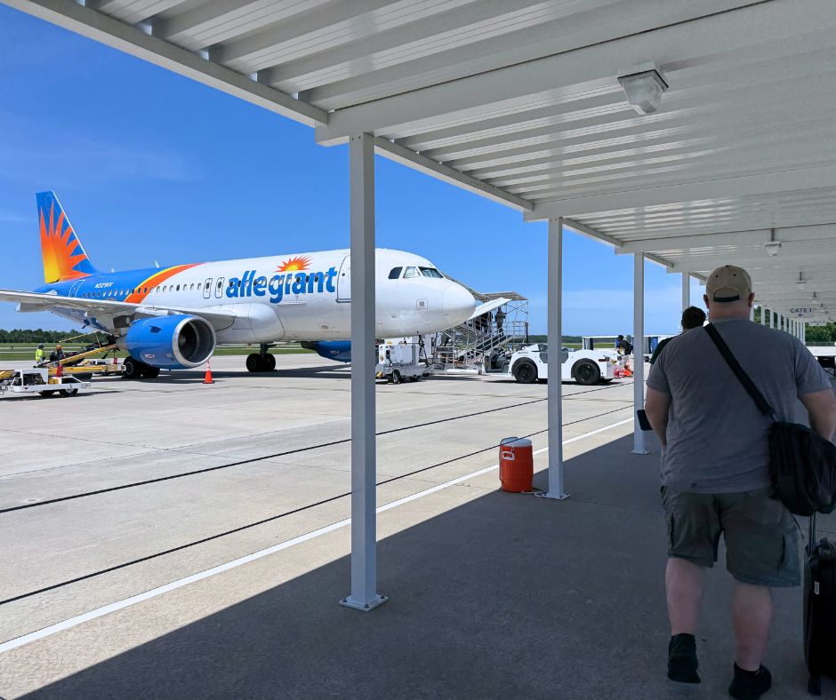People walk to the Allegiant airplane on the tarmac in Gulf Shores, Alabama
