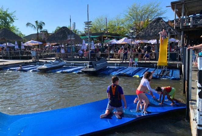 Kid play in the water in front of the Barefoot Bar in Okoboji