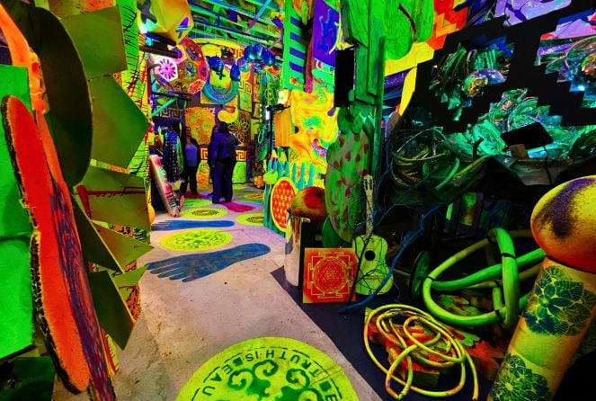 People stand in the background at the Immersive Art Fun House in Fairfield, Iowa