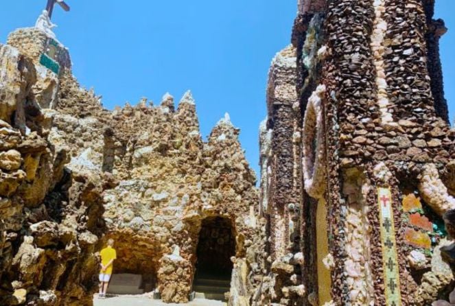 A boy stands in the background at the Shrine of the Grotto of the Redemption