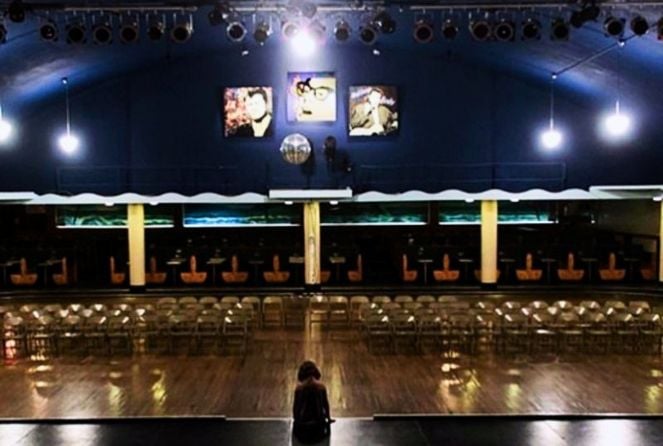 A girl sit on the stage at Surf Ballroom in Clear Lake.