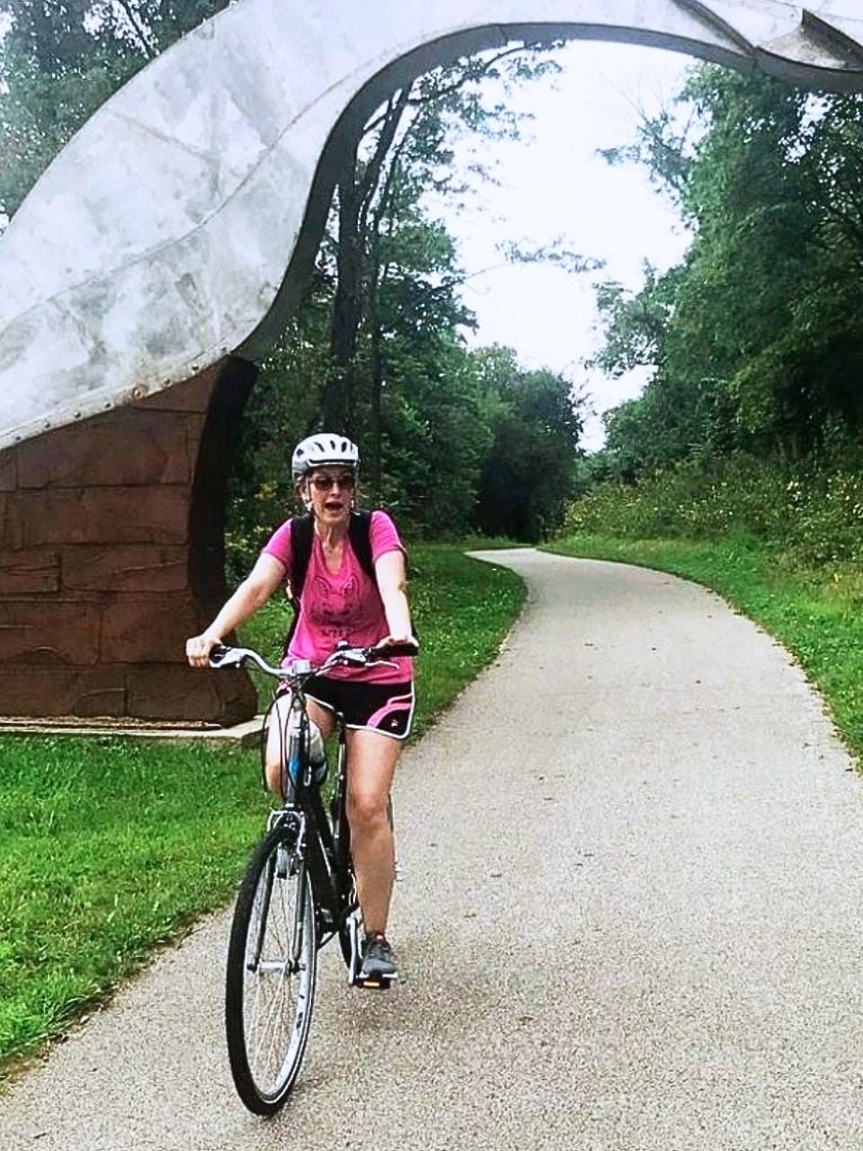 Kim on a bike on the paved trail, Trout Run Trail in Decorah.